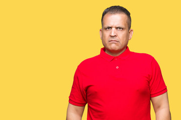 Obraz premium Middle age arab man over isolated background Relaxed with serious expression on face. Simple and natural looking at the camera.