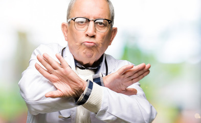 Handsome senior doctor man wearing medical coat Rejection expression crossing arms and palms doing...