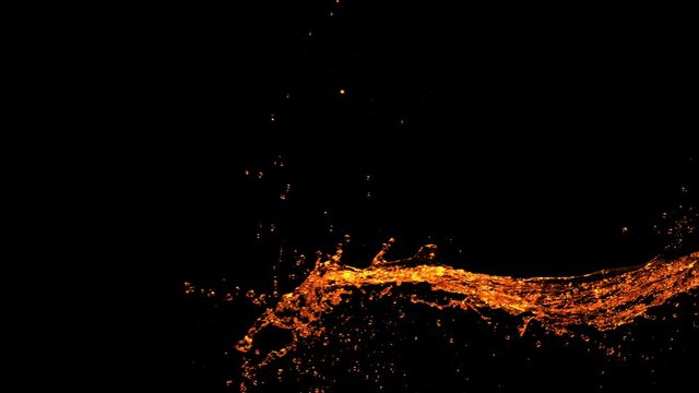 Super Slow Motion Shot of Golden Splash at 1000fps Isolated on Black Background.