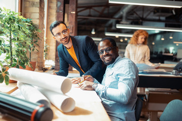 Interior designer smiling while working with smart colleague