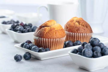 Muffins and blueberry on white table.