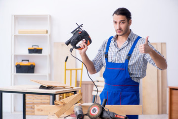Young male carpenter working indoors 