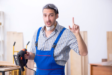 Young male carpenter working indoors 