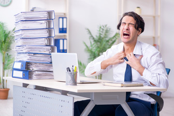 Young male employee unhappy with excessive work