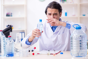 Young male chemist experimenting in lab