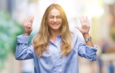 Young beautiful blonde business woman wearing glasses over isolated background showing and pointing...