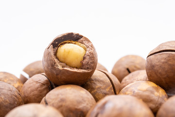 Fruits of the Australian macadamia nut on a white background. Kernels with a Shelled Shell