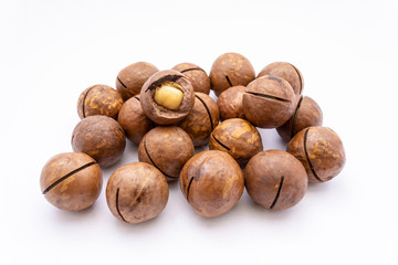 Fruits of the Australian macadamia nut on a white background. Kernels with a Shelled Shell