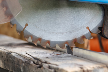 Old timber strip with teeth circular saw in workshop