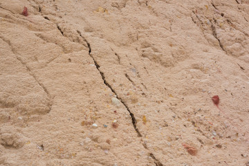 Colored yellow fine sand texture and cracks after being wet by the rain