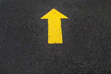 yellow arrow on asphalt