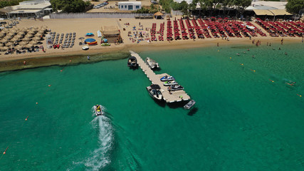 Fototapeta na wymiar Aerial drone photo of iconic organised beach of Super Paradise with emerald clear sandy seascape, Mykonos island, Cyclades, Greece