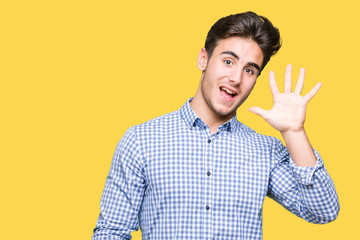 Young handsome business man over isolated background showing and pointing up with fingers number five while smiling confident and happy.