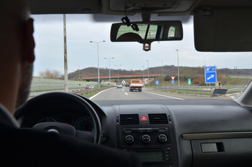 Businessman driving a car on a highway