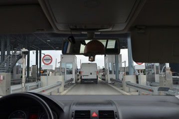 Car approaching a gateway in a pay toll on a highway