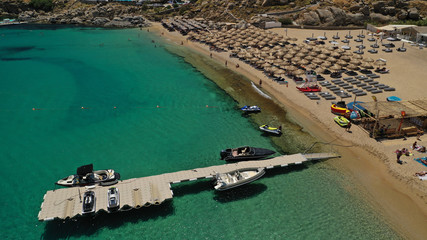 Aerial drone photo of iconic organised beach of Super Paradise with emerald clear sandy seascape, Mykonos island, Cyclades, Greece