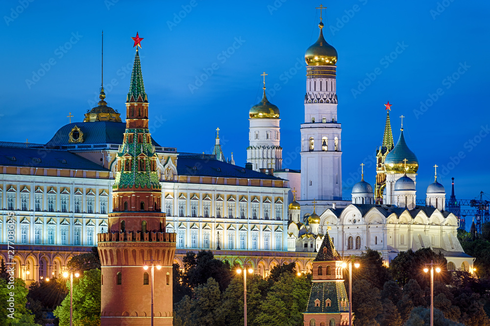 Wall mural Moscow Kremlin close-up at night, Russia. It is a top tourist attraction of Moscow. Beautiful view of the ancient Moscow Kremlin in summer evening. Famous Moscow landmark with old churches at dusk.