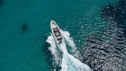 Aerial top view luxury inflatable rib speed boat cruising in mediterranean deep blue sea