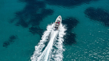 Aerial top view luxury inflatable rib speed boat cruising in mediterranean deep blue sea