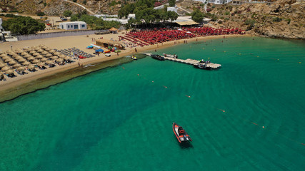 Aerial drone, bird's eye view photo of iconic and famous beach of Super Paradise with sapphire clear waters, Mykonos island, Cyclades, Greece