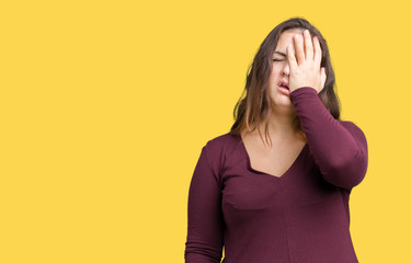 Beautiful and attractive plus size young woman wearing a dress over isolated background Yawning tired covering half face, eye and mouth with hand. Face hurts in pain.