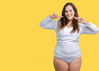 Beautiful plus size young overwight woman wearing white underwear over isolated background smiling confident showing and pointing with fingers teeth and mouth. Health concept.