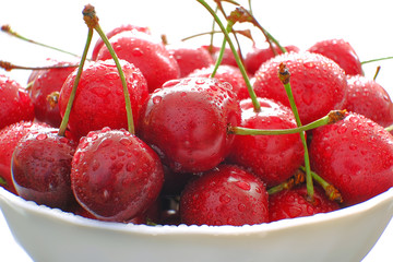 Beautiful bouquet of cherries. Fresh ripe red berries, stems and drops of water. Selective focus.