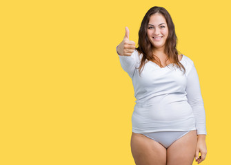 Beautiful plus size young overwight woman wearing white underwear over isolated background doing...