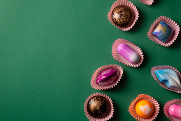 Bonbons set from above on green