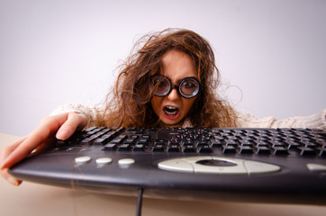 Funny nerd girl working on computer