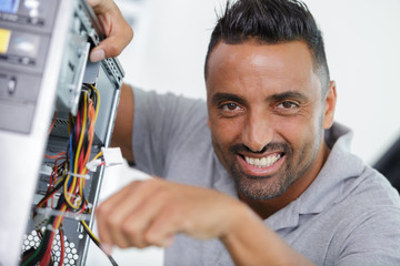 Fototapeta na wymiar male teacher fixing a computer