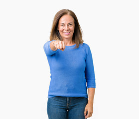 Middle age beautiful woman wearing winter sweater over isolated background Punching fist to fight, aggressive and angry attack, threat and violence