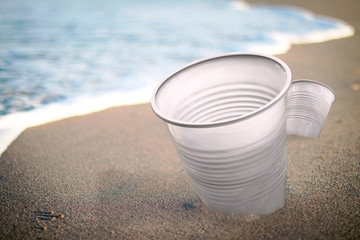 plastic cup in the sand. Environmental pollution. Ecological problem 