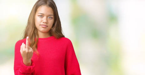Young beautiful brunette woman wearing red winter sweater over isolated background Showing middle...
