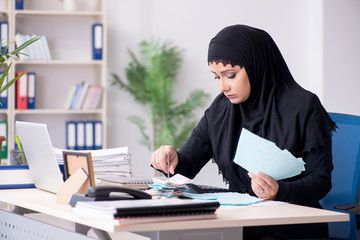 Female employee bookkeeper in hijab working in the office 