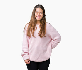 Young beautiful brunette woman wearing pink winter sweater over isolated background with a happy and cool smile on face. Lucky person.