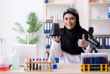 Female chemist in hijab working in the lab