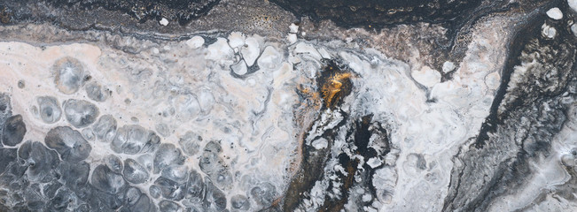 photography of abstract marbleized effect background. black, gold and white creative colors. Beautiful paint