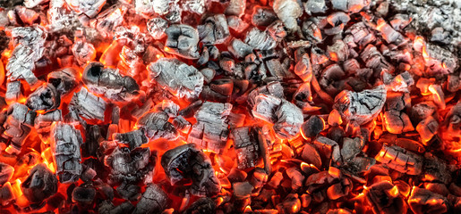 Burning coals from a fire abstract background.