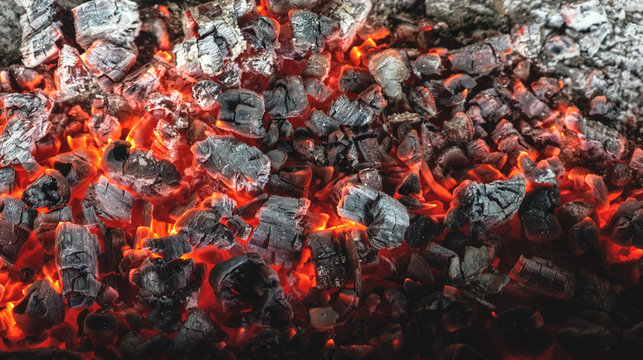 Burning coals from a fire abstract background.