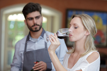 a woman tasting free wine