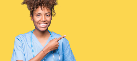 Young african american doctor woman over isolated background cheerful with a smile of face pointing...