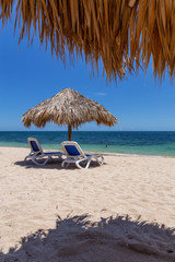 Beautiful view of a sandy beach, Playa Ancon, on the Caribbean Sea in Triniday, Cuba, during a bright and sunny day.