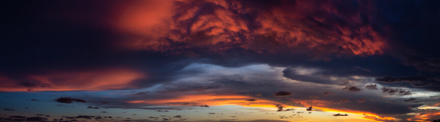 Dramatic Panoramic View of a cloudscape during a dark and colorful sunset. Taken over Beach Ancon in Trinidad, Cuba.