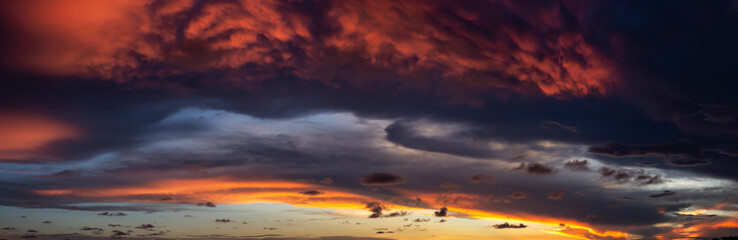 Dramatic Panoramic View of a cloudscape during a dark and colorful sunset. Taken over Beach Ancon...