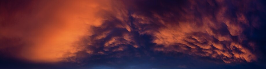 Dramatic Panoramic View of a cloudscape during a dark and colorful sunset. Taken over Beach Ancon in Trinidad, Cuba.