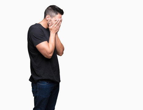 Young handsome man over isolated background with sad expression covering face with hands while crying. Depression concept.