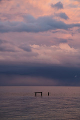 Dramatic View of a cloudscape over the Ocean during a dark, rainy and colorful morning sunrise....