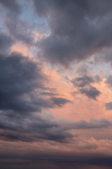 Dramatic View of a cloudscape during a dark, rainy and colorful morning sunrise. Taken over Beach...