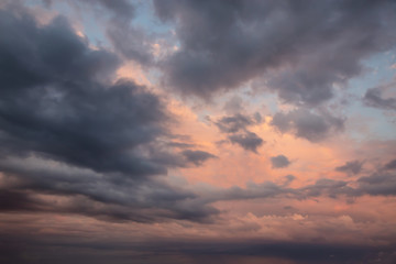 Dramatic View of a cloudscape during a dark, rainy and colorful morning sunrise. Taken over Beach Ancon in Trinidad, Cuba.